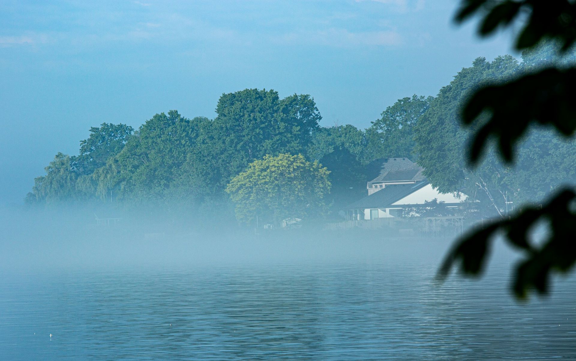 Mist over a calm lake at morning