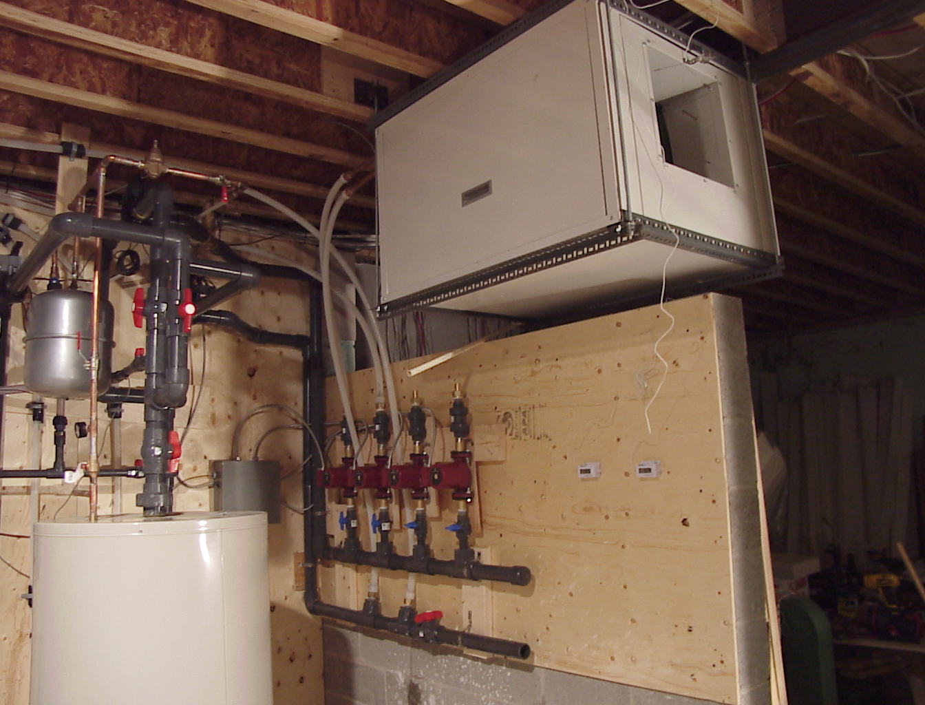 Ceiling-hung air handler in a mixed mechanical installation; heat pump model unconfirmed; exact model unconfirmed
